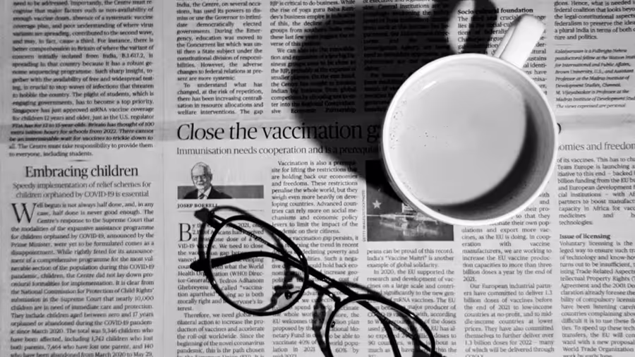 An image of a newspaper and a coffee